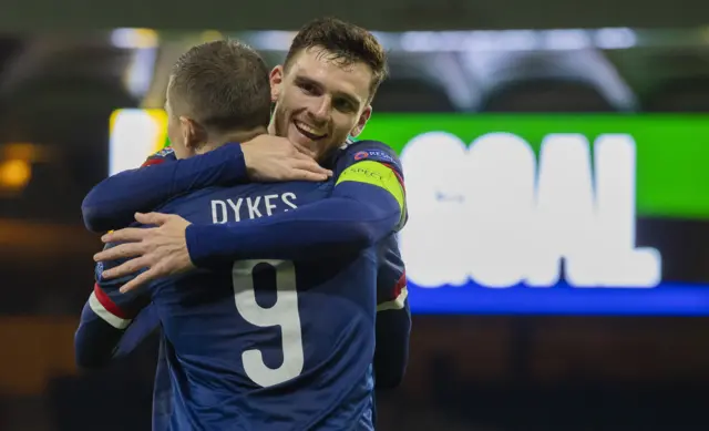 Andrew Robertson congratulates Lyndon Dykes after the opening goal