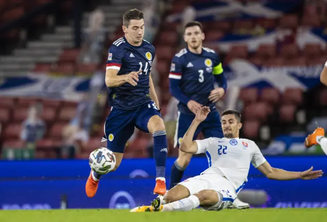 Kenny McLean skips a challenge from Martin Koscelnik