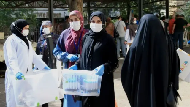 Nurses from the Great Prophet Hospital carry blood samples of people tested for Covid-19 at coronavirus in the Haret Hreik area of Beirut, Lebanon, 8 October 2020