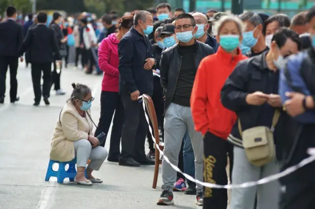 Residents wait to be tested for the COVID-19 coronavirus in Qingdao