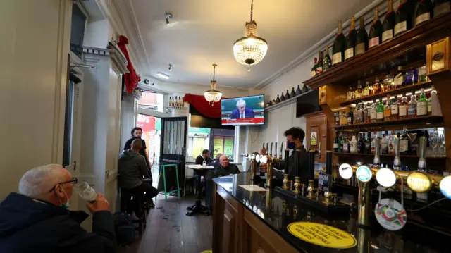 People in the Richmond pub in Liverpool watch a statement by the Prime Minister Boris Johnson, as parts of the North of England are bracing themselves for the most stringent Tier 3 controls