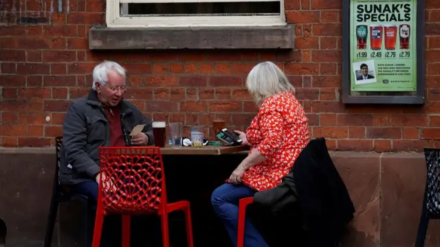 Two people sit at a pub in Manchester