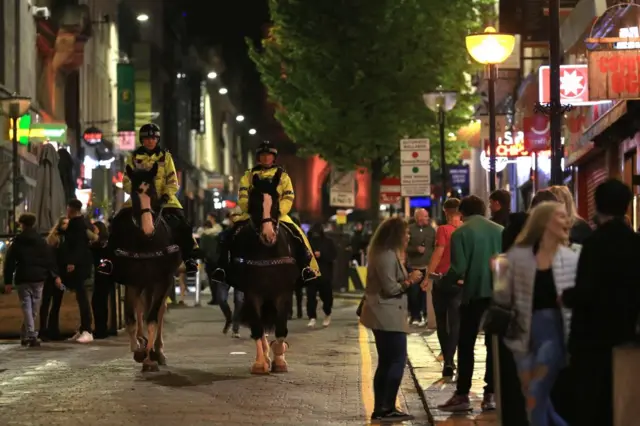 Police patrol as revellers enjoy a night out in the centre of Liverpool on October 10, 2020