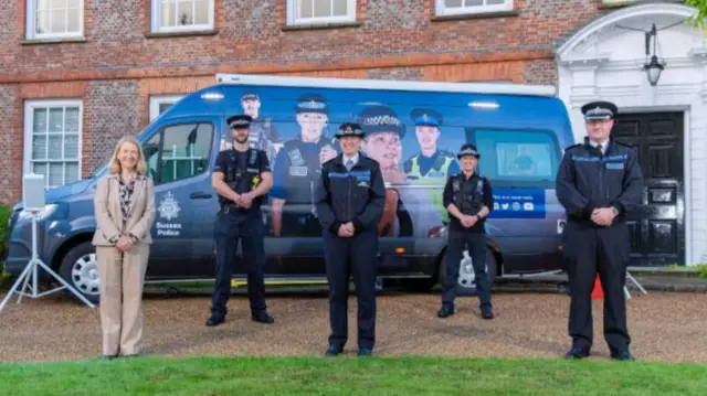 Police officers outside the decorated bus