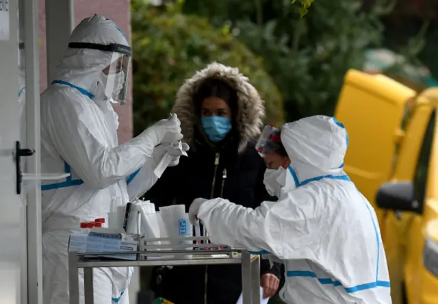 Medical staff wearing a protective suit test people at a drive-in testing facility on October 13, 2020 in Zagreb, amid the crisis linked with the covid-19 pandemic caused by the novel coronavirus