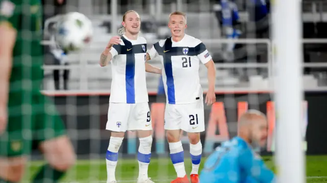 Finland's Fredrik Jensen celebrates scoring their opener with Ilmari Niskanen