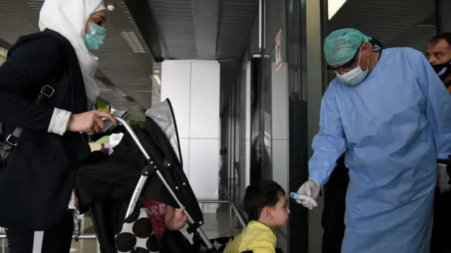 A doctor checks a child's temperature