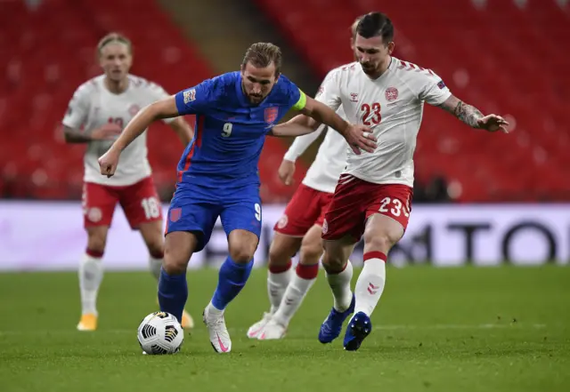 Harry Kane of England battles for possession with Pierre Emile Hoejbjerg of Denmark