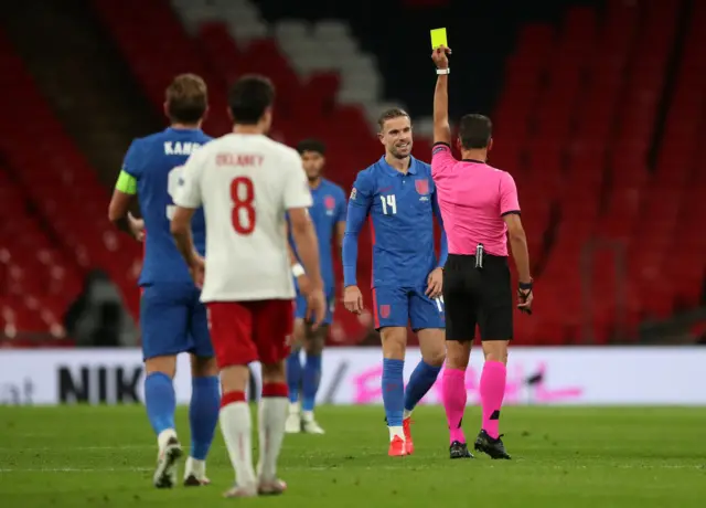 Jordan Henderson is shown a yellow card