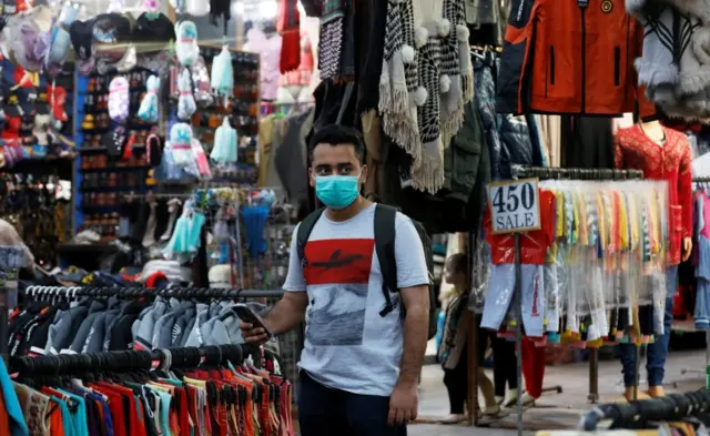 A man wearing a protective mask pauses along a market amid the coronavirus disease (COVID-19) pandemic, in Karachi, Pakistan, 6 October 2020