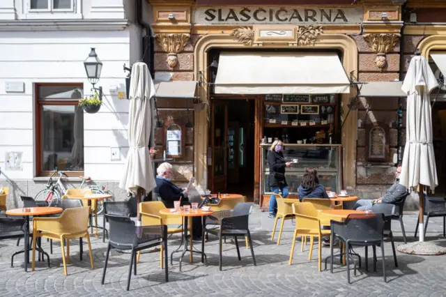 People sit at a cafe terrace in Ljubljana, in May 2020, on the first day of lockdown being eased