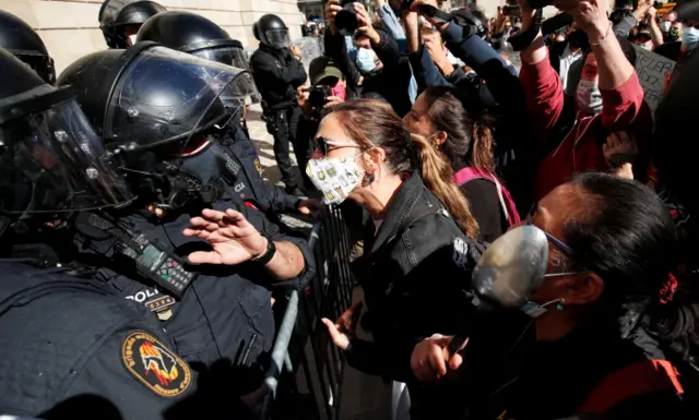 Workers from the hospitality sector confront police