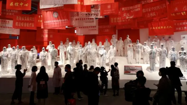 Visitors are seen at a newly opened exhibition on Wuhan's fight against coronavirus on 15 October 2020