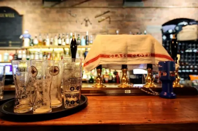 Empty glasses on bar in pub