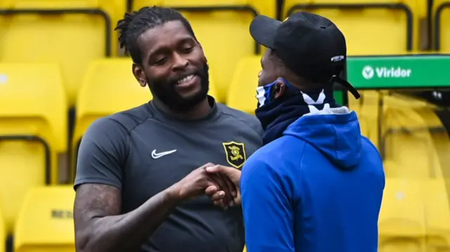 Livingston's Jay Emmanuel-Thomas and Kilmarnock's Aaron Tshibola exchange a warm welcome before their side's clash today