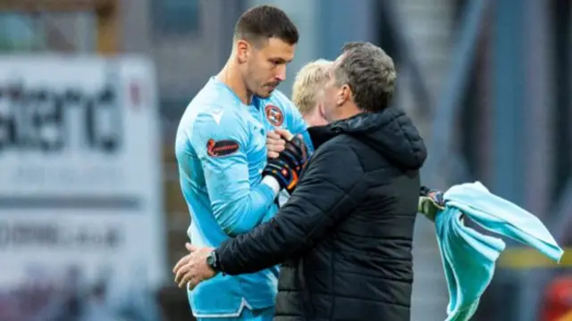 Dundee United manager Micky Mellon congratulates his goalkeeper