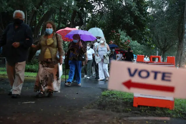 People queue outside to vote