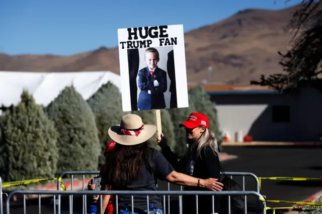 'Huge Trump Fan' placard held up at his rally