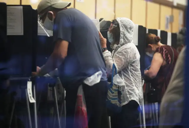 People wear face shields as they vote in Florida