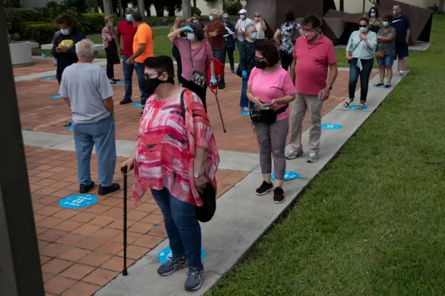 Voters wait in line, socially distanced from each other, to cast their early ballots at the Westchester Regional Library polling station on October 19