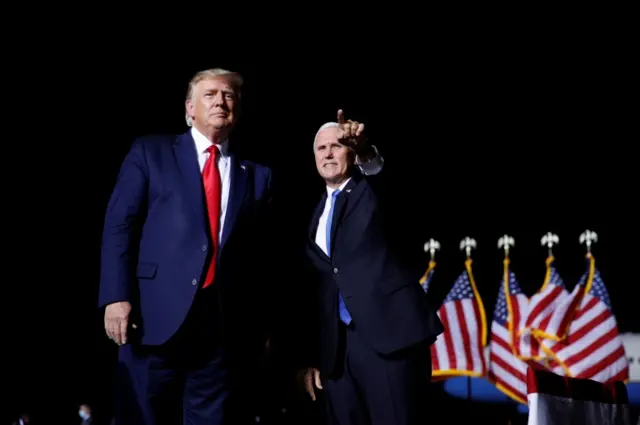 Vice President Mike Pence points to the crowd as U.S. President Donald Trump arrives at a campaign rally in Newport News