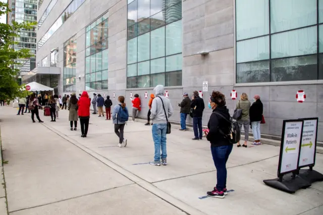 People queue at a testing centre in Toronto