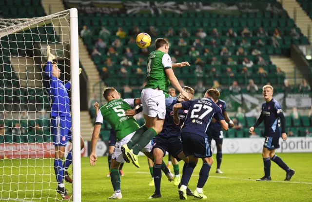 Paul Hanlon heads in Hibs' third goal of the evening at Easter Road