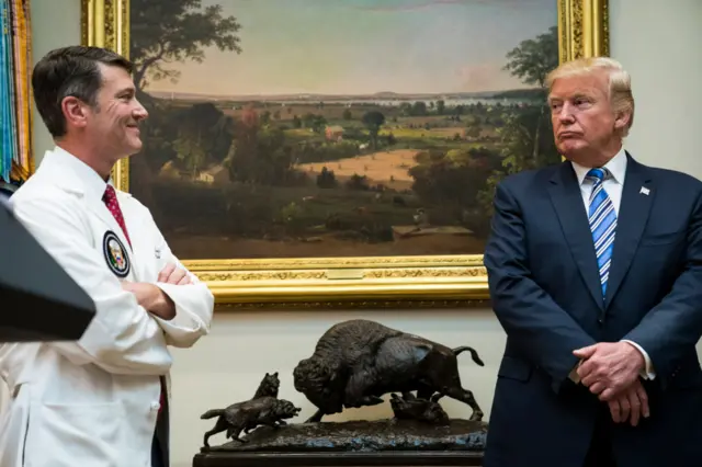 Dr Ronny Jackson with Donald Trump in the White House in August 2017