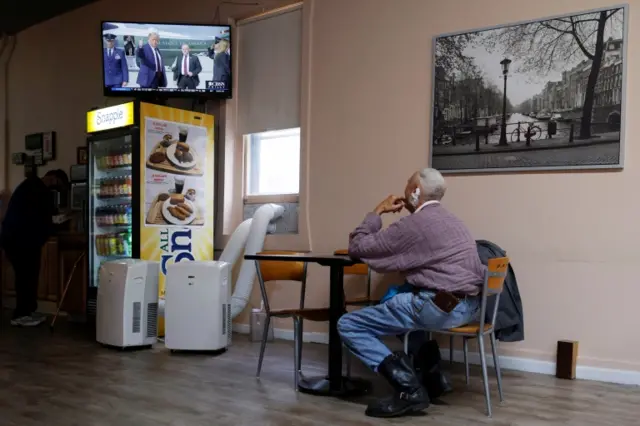 A diner watches a news report about President Trump in Pennsylvania