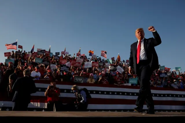 Donald Trump gestures after a campaign rally in Tucson, Arizona, 19 October