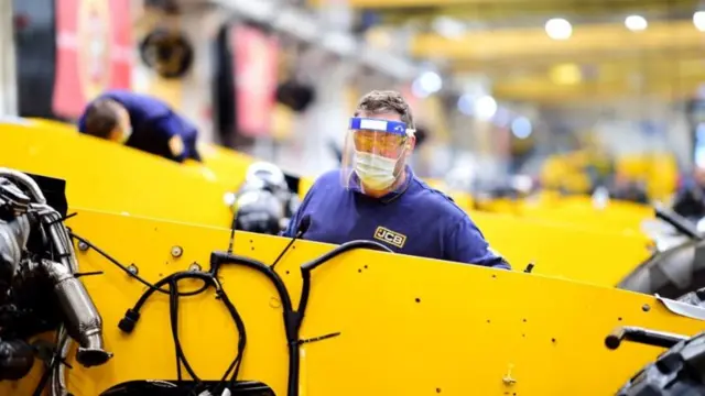 JCB worker in visor on production line