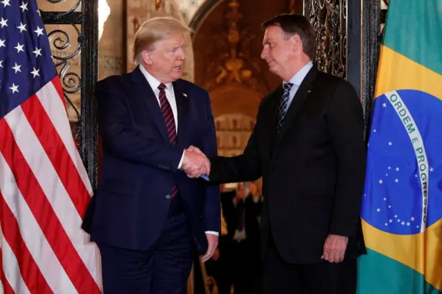 President Donald Trump shakes hands with Brazilian President Jair Bolsonaro in Mar-a-Lago, March 2020