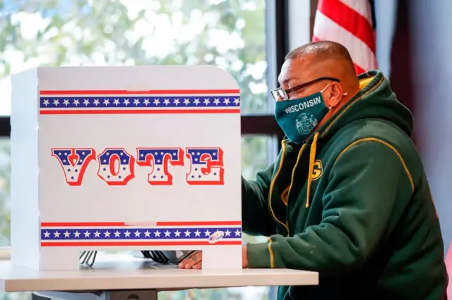 A voter casts in ballot in Wisconsin