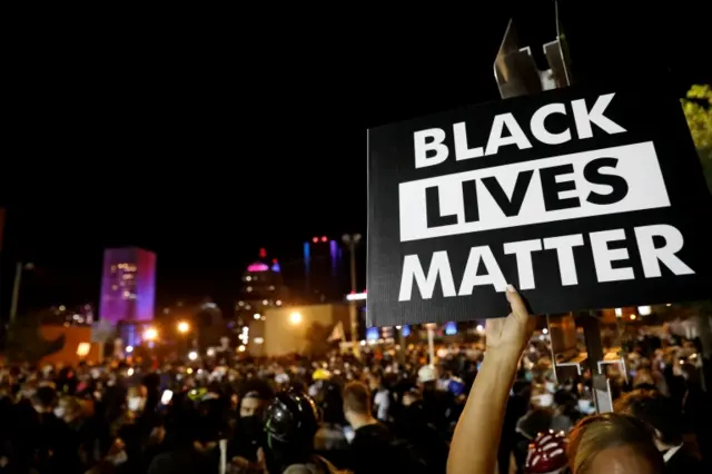 A demonstrator holds up a "Black Lives Matter" sign during a protest over the death of a Black man, Daniel Prude, September 2020