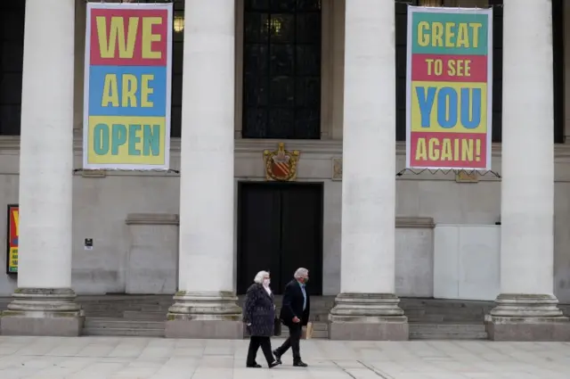 Two people walking in Manchester