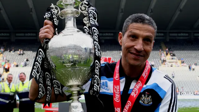 Chris Hughton celebrates the Championship title at Newcastle