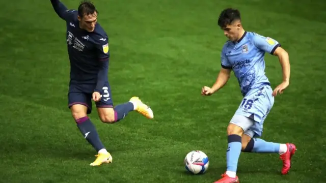 Swansea City"s Connor Roberts (left) and Coventry City"s Ryan Giles battle for the ball