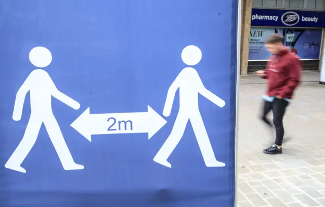 Man and 2m sign