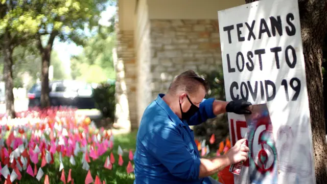 Shane creates a poster saying: Texans Lost to Covid 156"