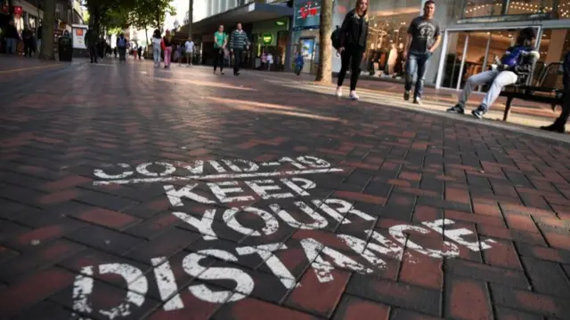 A Covid-19 social distancing public notice on a street in Birmingham