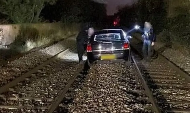 Car on train tracks