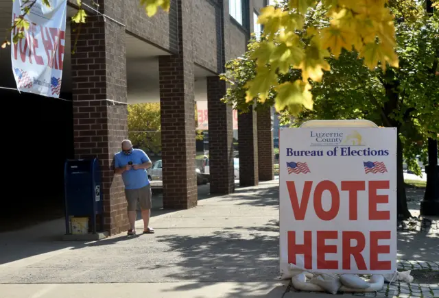 A man waits outside the Luzerne County Board of Elections where people drop off and request for mail-in ballots