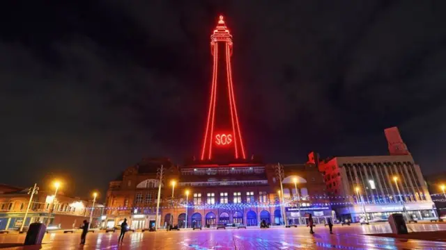 Blackpool Tower lit up with the letters "SOS"