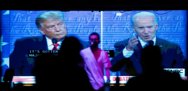 People watch the second 2020 presidential campaign debate on a big screen