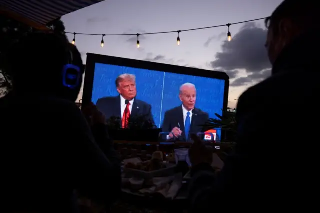 Large screen broadcasts the debate outdoors at a tavern in San Diego, on 22 October 2020