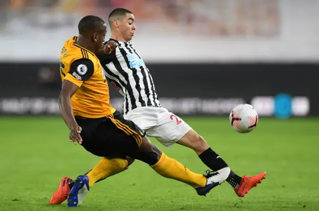 Newcastle's Miguel Almiron tackles Willy Boly