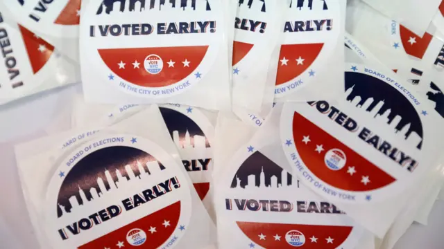 Stickers are seen at a polling station during early voting in The Bronx, New York City.