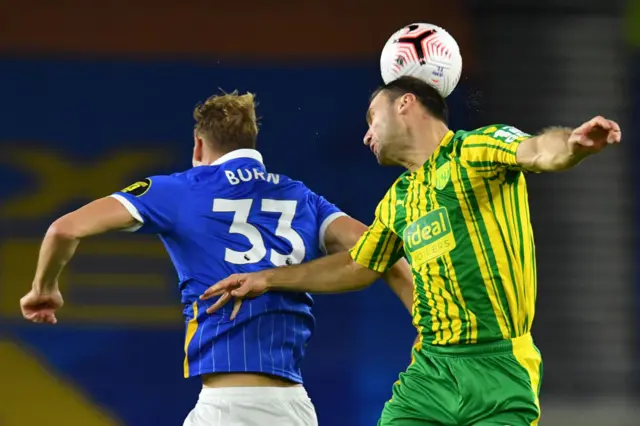 Brighton's defender Dan Burn vies with West Bromwich Albion defender Branislav Ivanovic