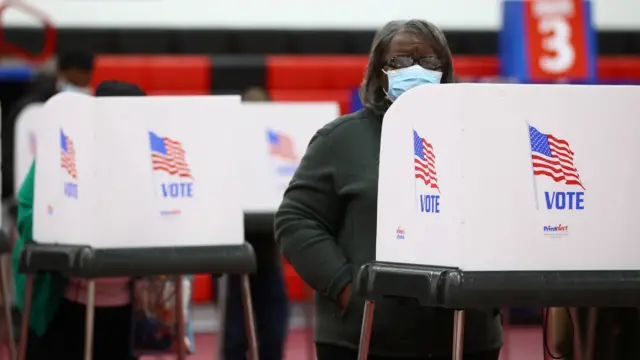 People fill out ballots in privacy booths at a polling station located in the Baltimore City Community College (BCCC) Gymnasium in Baltimore, during early voting in Maryland.