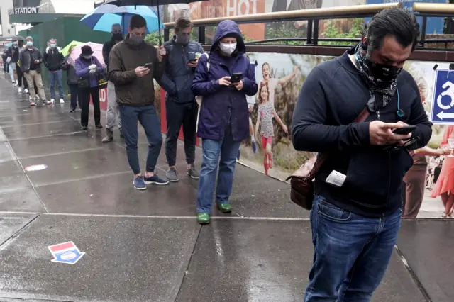 People line up in the rain to vote at an early voting site at Madison Square Gardens in the Manhattan borough of New York City.